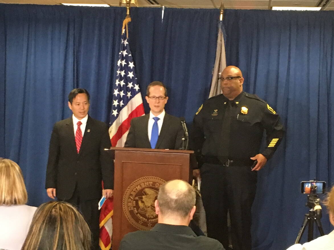 IRS Acting Special Agent in Charge William Cheung (left), and Police Chief Eliot Isaac (right), join US Attorney Ben Glassman Friday afternoon to announce charges.